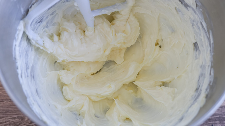 the bowl of a stand mixer with cream cheese and butter