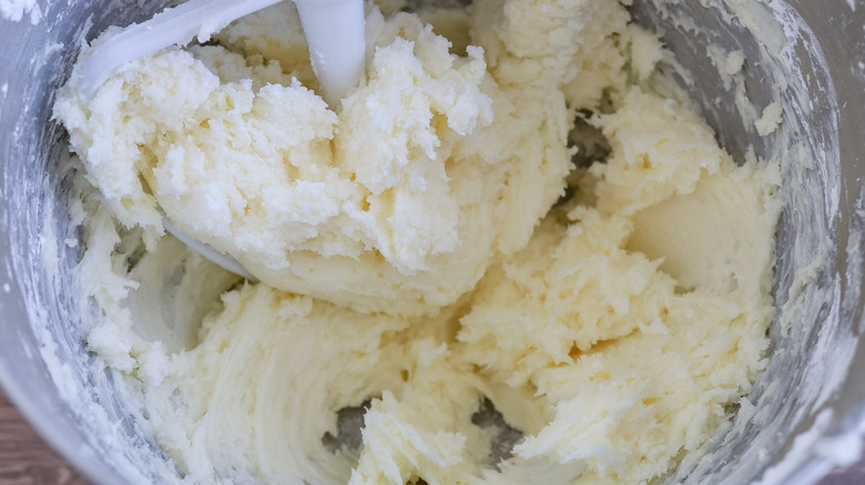 the bowl of a stand mixer mixing frosting