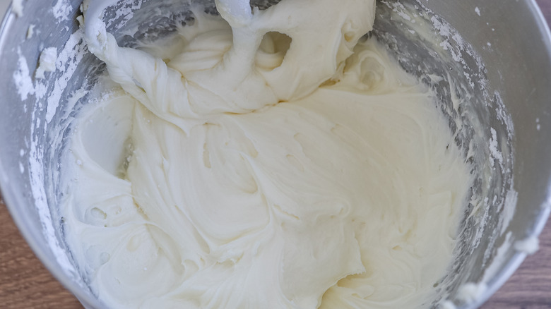 the bowl of a stand mixer with finished spiked margarita cupcake frosting