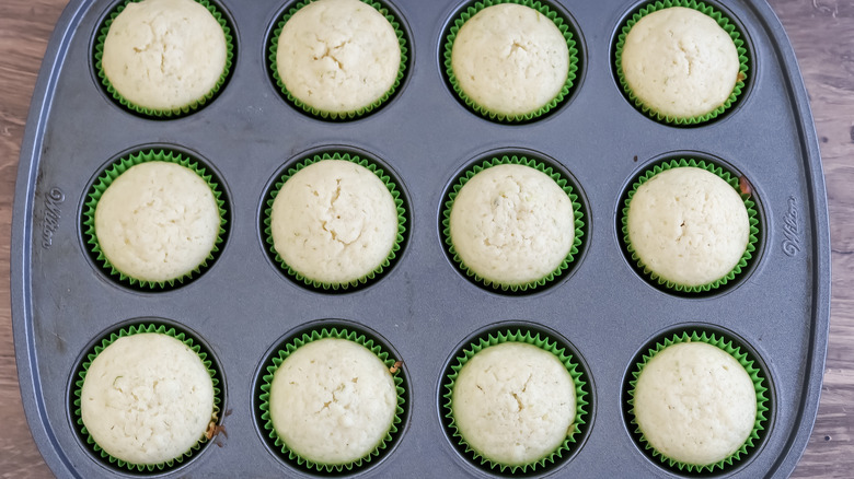 cupcake pan with baked cupcakes in it