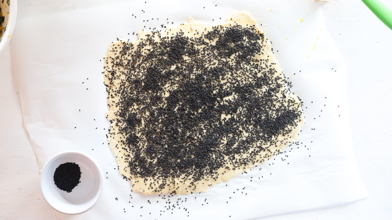 dough sheet sprinkled with sesame seeds