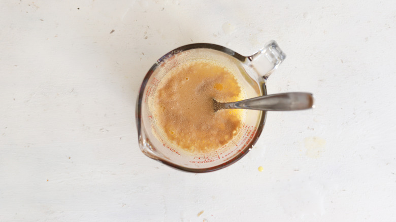 yeas, egg, and salt in a measuring cup