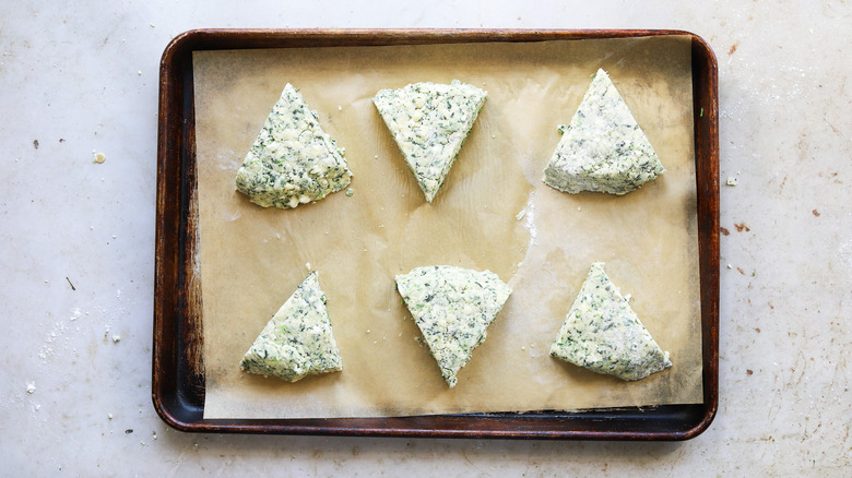 unbaked spinach scones on baking sheet