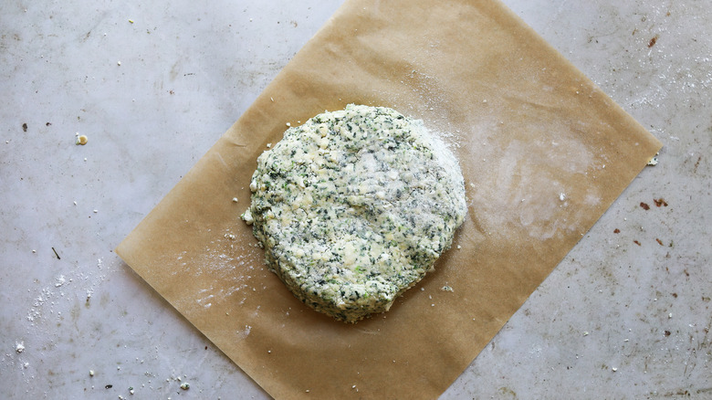 spinach scone dough pressed into circle