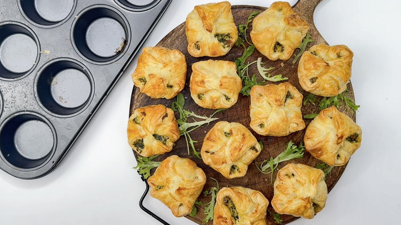 Spinach puffs on wooden tray