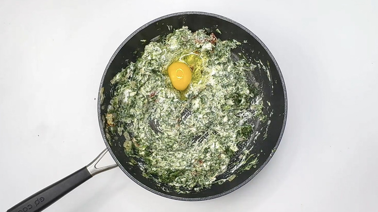 stirring egg into spinach mixture