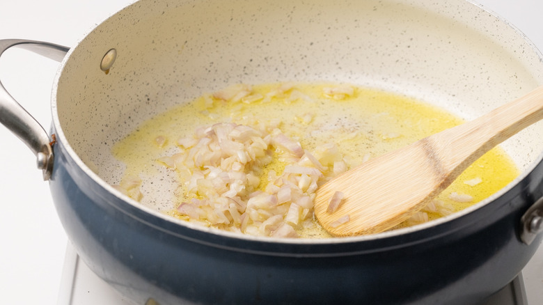 sautéing shallots in a pan