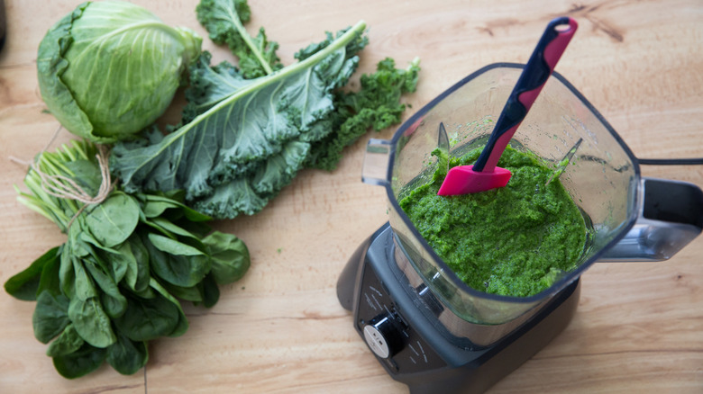 blender and vegetables on table