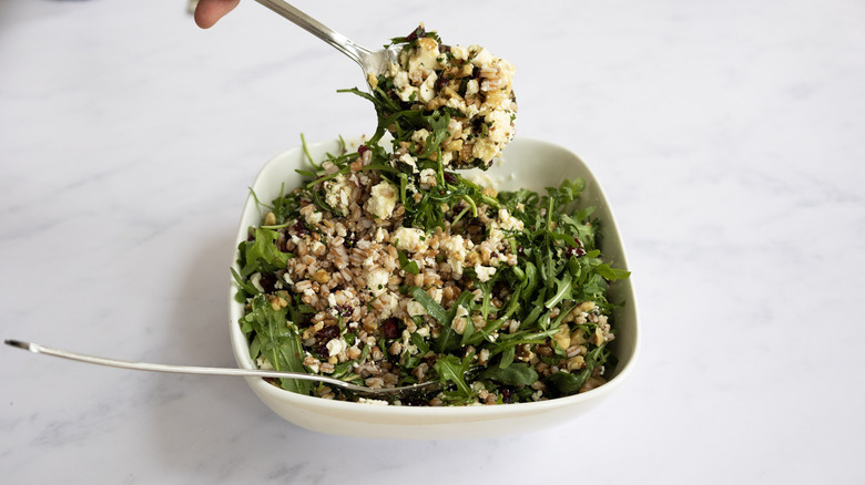 mixing farro salad ingredients