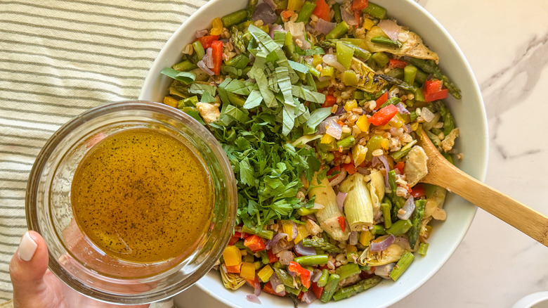 adding dressing to bowl