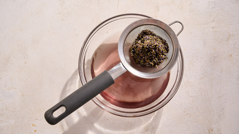 straining lavender into a bowl