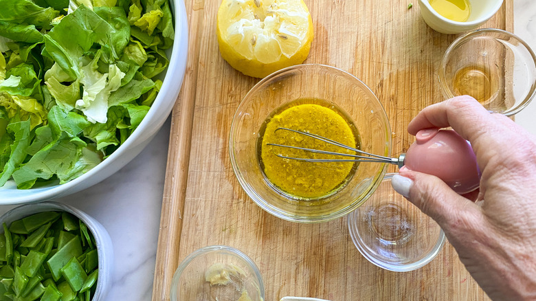 hand whisking dressing in bowl