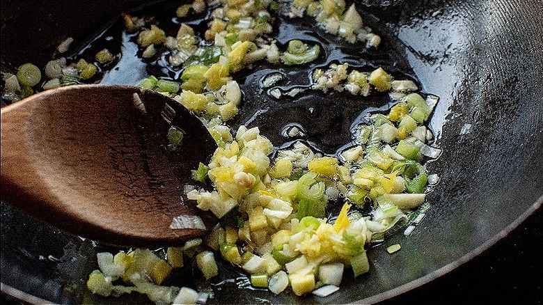 stirring garlic and ginger in wok