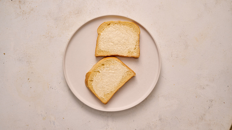 butter spread on slices of bread