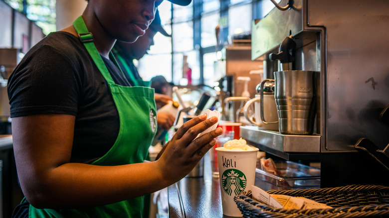 Starbucks barista making drink