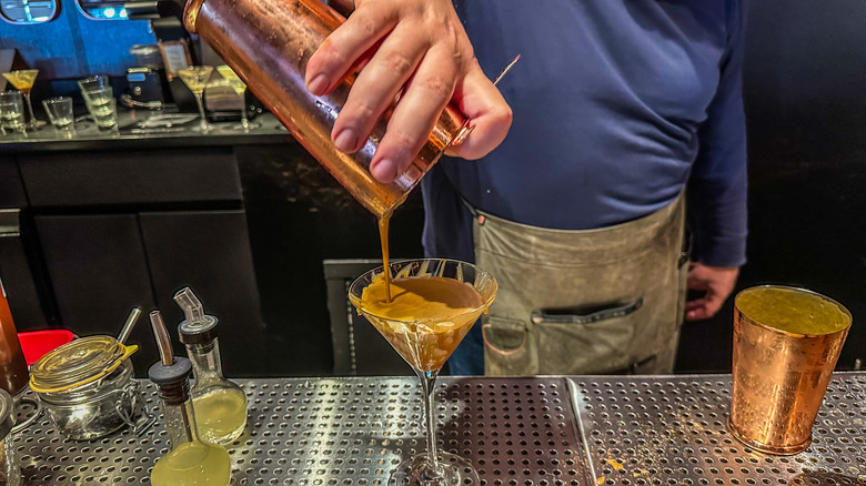 bartender pouring a martini