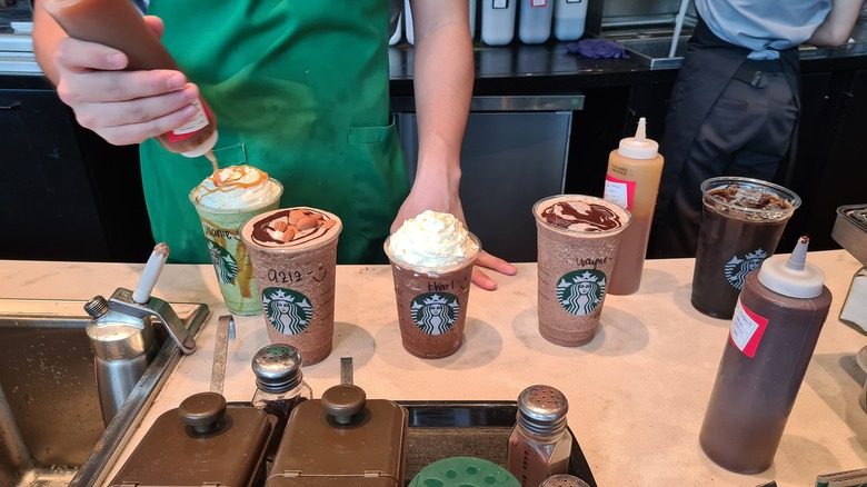 Barista makes beverages at Starbucks