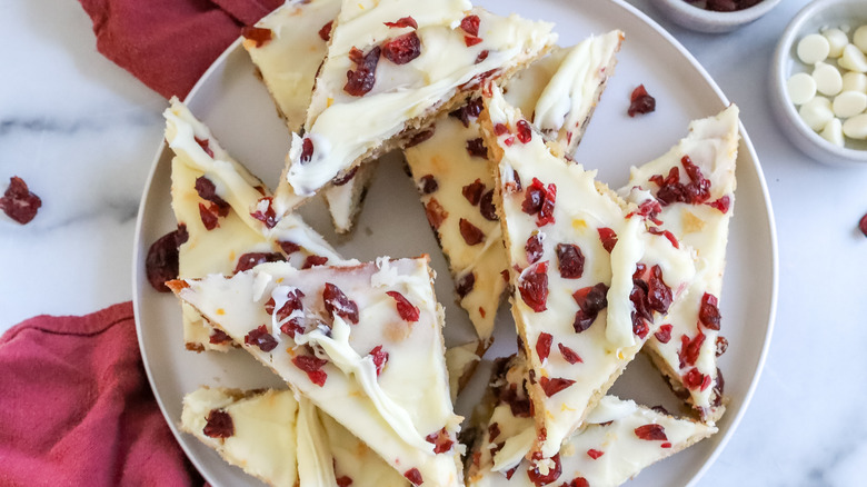 cranberry bliss cheesecake bars on a plate