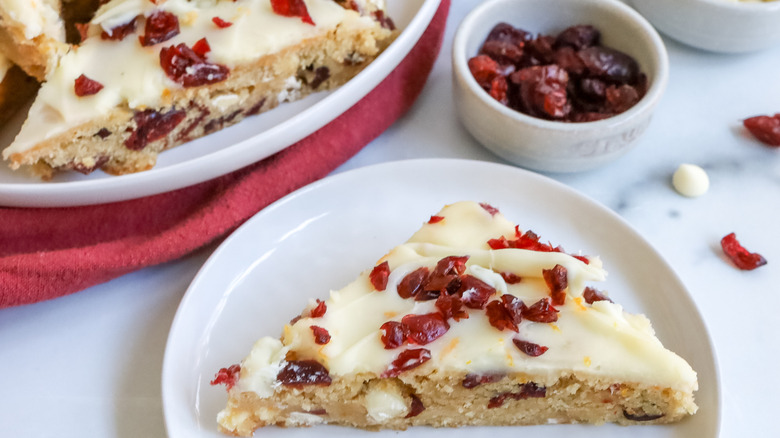 a cranberry bliss cheesecake bar on a plate