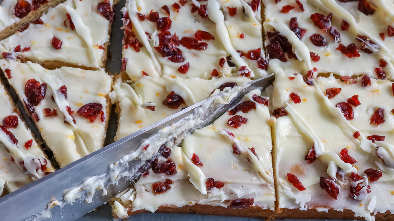 cranberry bliss cheesecake bars being cut