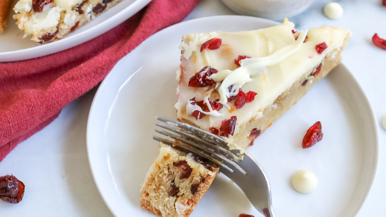 a Starbucks-inspired cranberry bliss cheesecake bar being cut with a fork