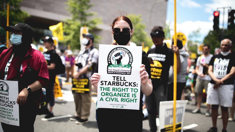 A protester holding a sign in support of Starbucks unionization