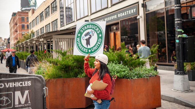 starbucks worker carrying union sign