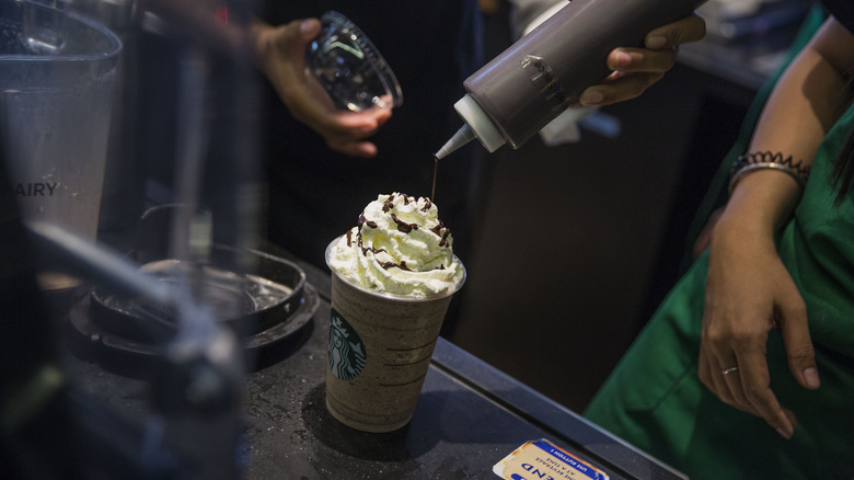 starbucks syrup pouring on drink