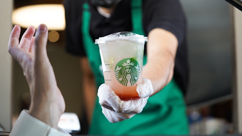 Starbucks barista handing out a drive-thru order