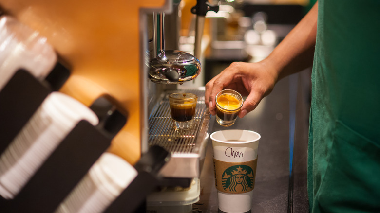 Starbucks barista making coffee drink 