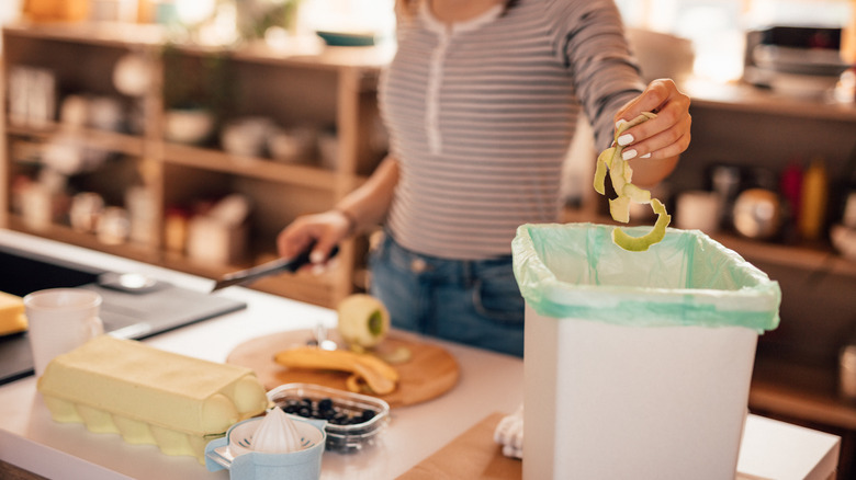 Home cook separating food scraps into a compost bin