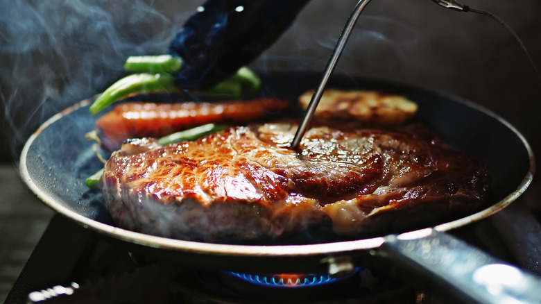 pan frying steak with vegetables 