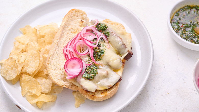 steak and chimichurri sandwich on plate