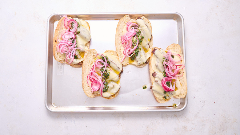 onions and chimichurri on sandwiches