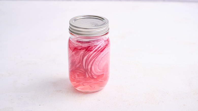 jar of pickled onions on table