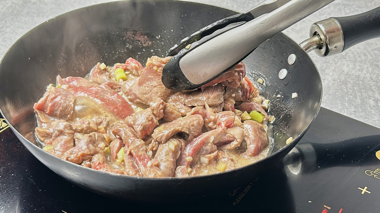 steak strips cooking in pan