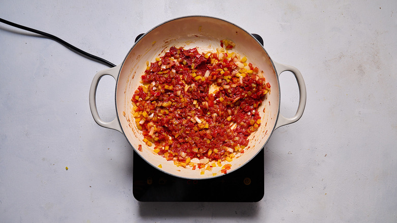 tomato onion pepper mixture cooking in pot