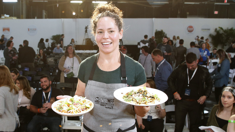 Stephanie Izard holding salads