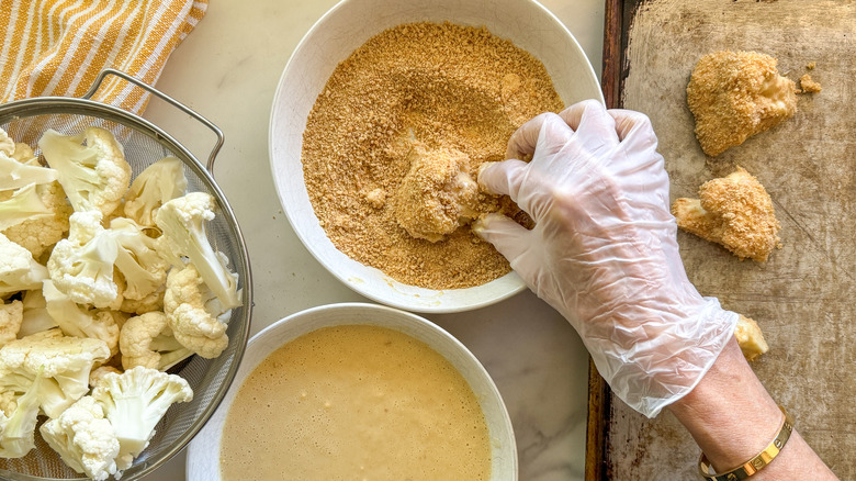 dipping the cauliflower in panko