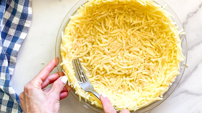 pressing potatoes in pie pan