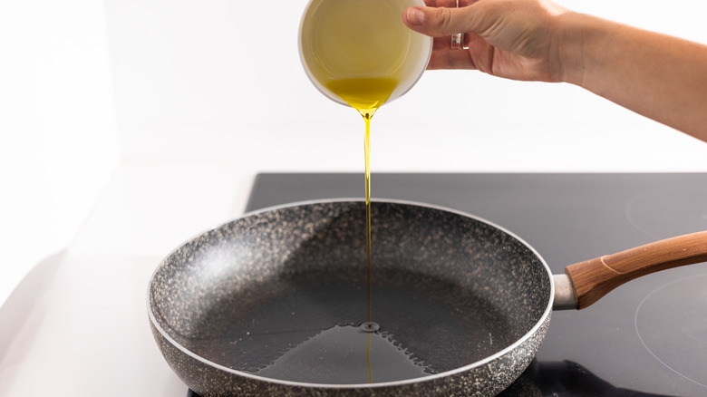 pouring oil into pan