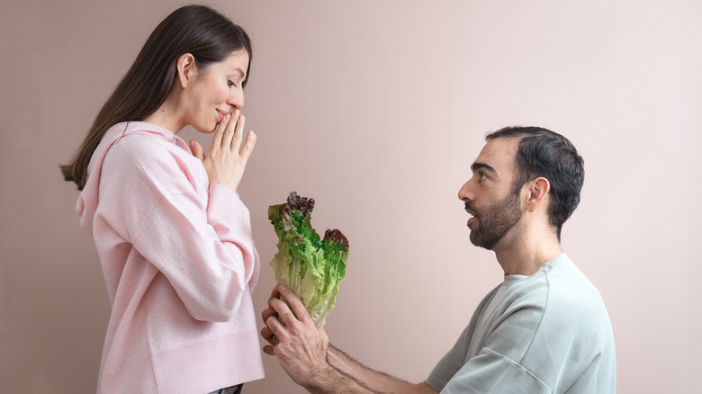 man proposing with lettuce
