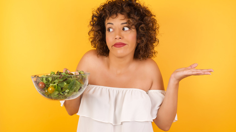 woman bewildered by salad