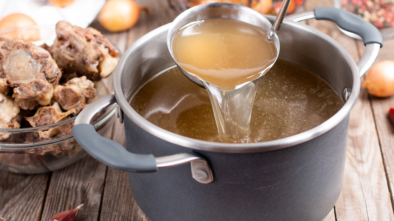 bone broth poured from ladle