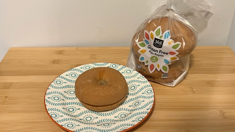 Whole Foods 365 gluten-free bagel on a plate with the package