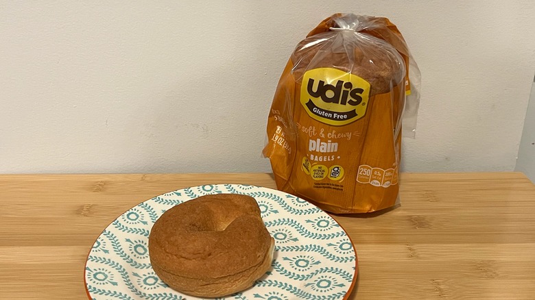 Udi's plain bagel on a plate with the package