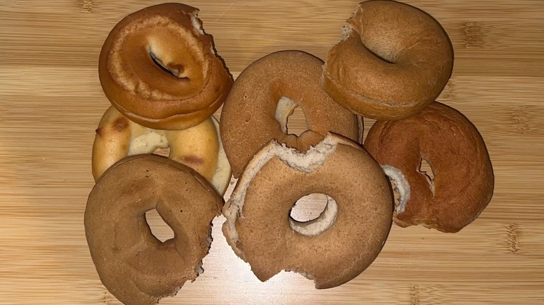 Different bagels with bites out of each on a table