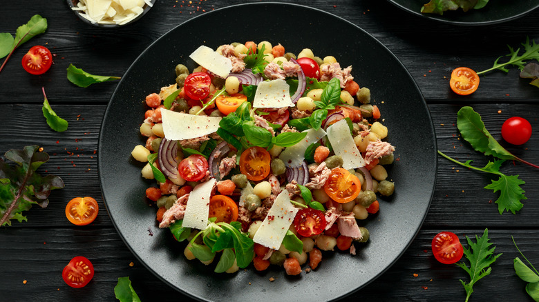 Gnocchi with cheese, tomatoes, and fish