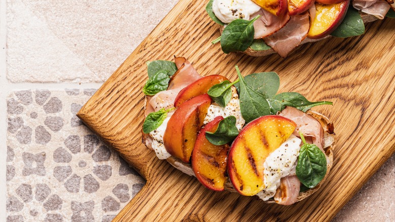 Peaches, prosciutto, and stracciatella cheese toast