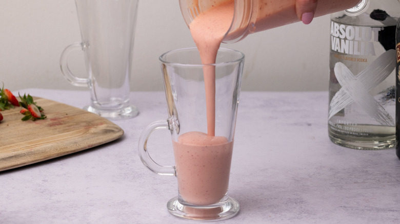 Pouring strawberries and cream cocktail